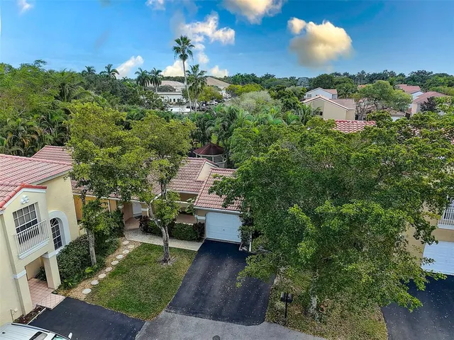 an aerial view of a house with a yard basket ball court and outdoor seating