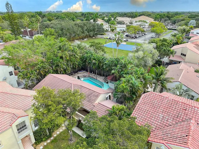 an aerial view of a house with a yard