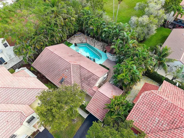 an aerial view of a house with garden space and street view