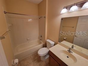 11637 Great Commission Way Orlando, FL 32832 - Photo 13 of 19 a bathroom with a sink mirror vanity and toilet
