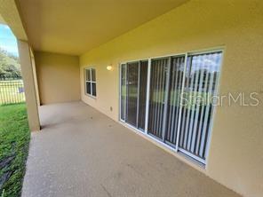 11637 Great Commission Way Orlando, FL 32832 - Photo 17 of 19 a view of a porch with wooden floor and fence