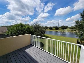 11637 Great Commission Way Orlando, FL 32832 - Photo 18 of 19 a balcony with wooden floor and lake view