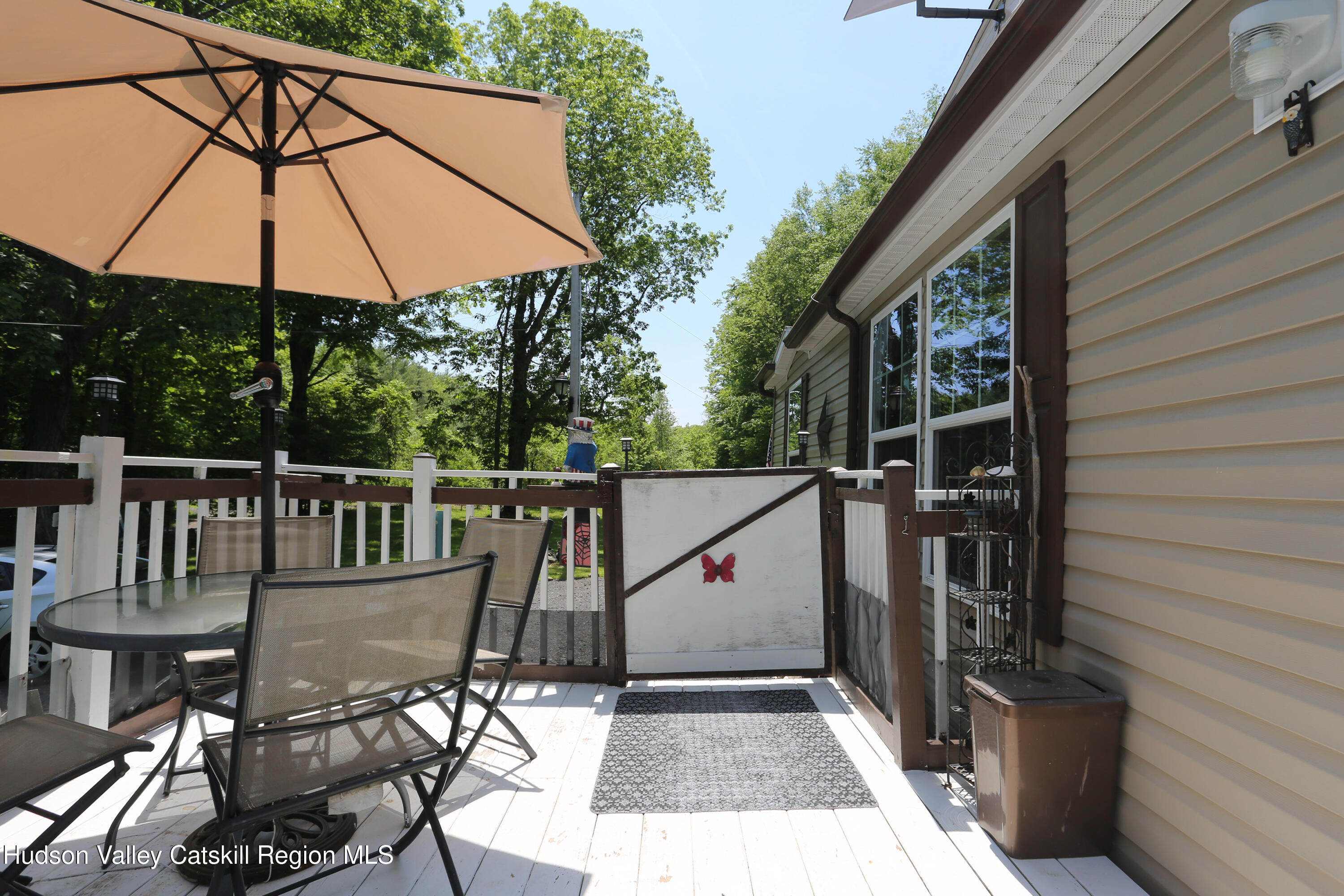 219 Edison Timmerman Road Cairo, NY 12413 - Photo 30 of 51 a view of deck with chairs and umbrella