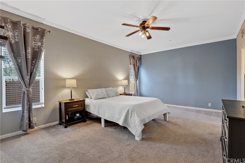 60600 Burnt Valley Road Anza, CA 92539 - Photo 15 of 46 a bedroom with a bed and a chandelier