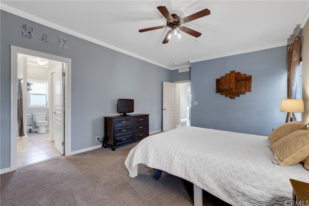 60600 Burnt Valley Road Anza, CA 92539 - Photo 16 of 46 a bedroom with a bed and a chandelier