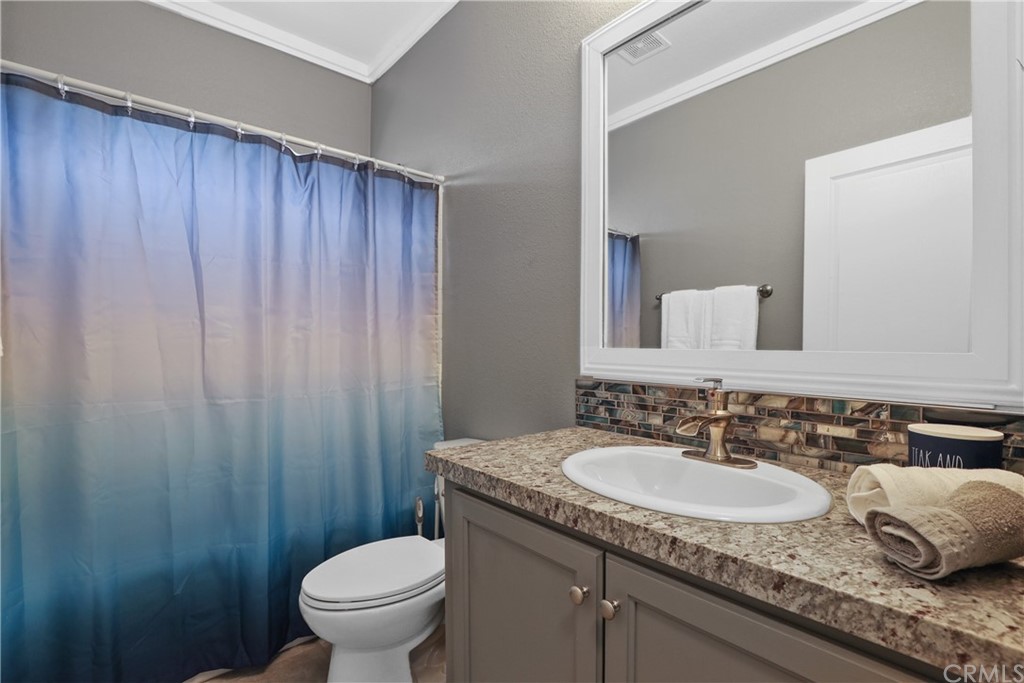60600 Burnt Valley Road Anza, CA 92539 - Photo 21 of 46 a bathroom with a granite countertop sink and a mirror