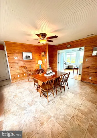 a living room with furniture a air conditioner vent and a window