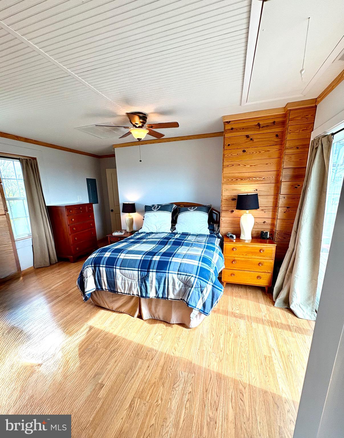 3419 Marsh Road Ewell, MD 21824 - Photo 22 of 34 a bedroom with a bed and wooden floor
