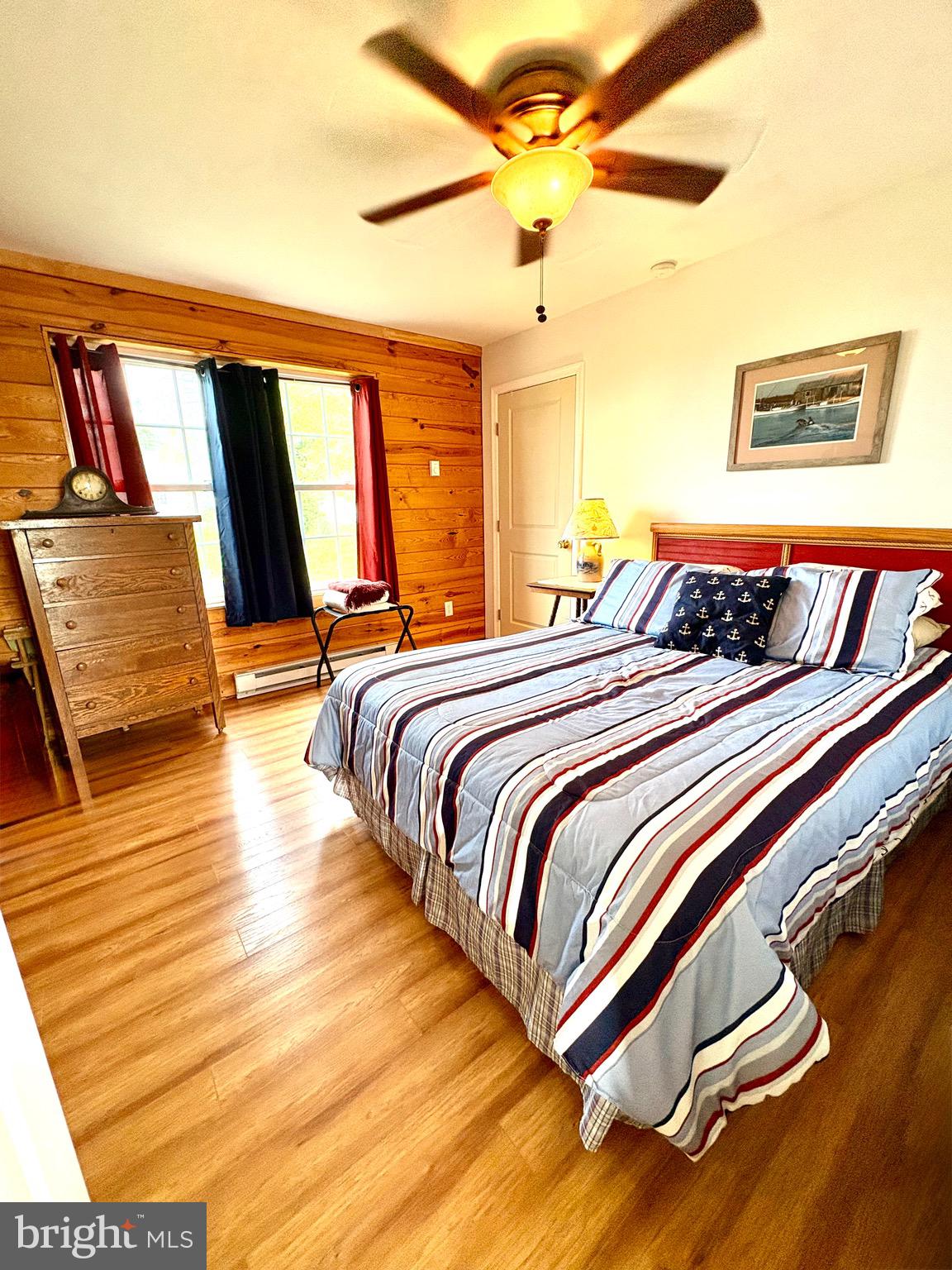 3419 Marsh Road Ewell, MD 21824 - Photo 10 of 34 a bedroom with a bed and wooden floor