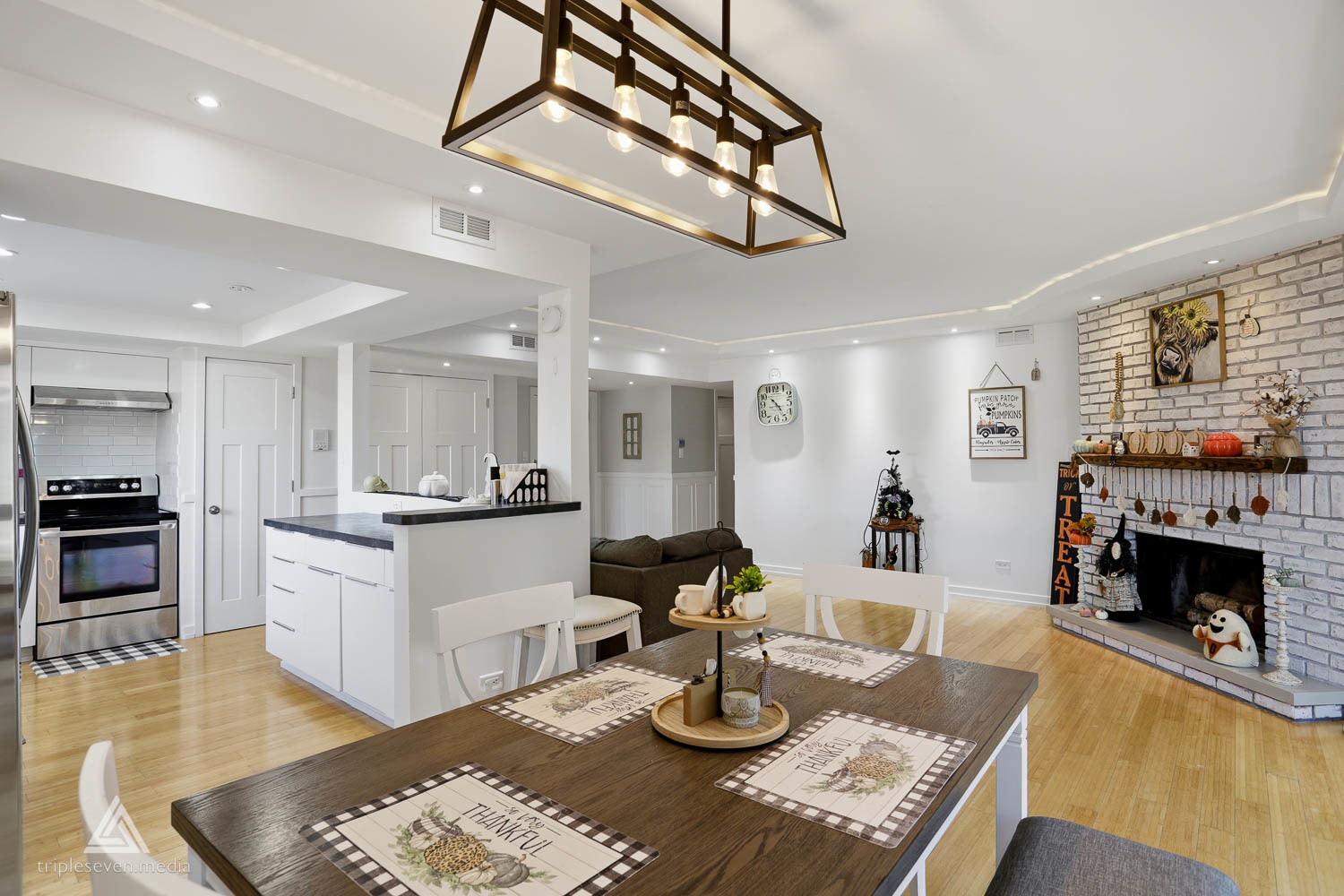 9180 S Road, Unit D Palos Hills, IL 60465 - Photo 6 of 24 a kitchen with stainless steel appliances granite countertop a stove and white cabinets with wooden floor