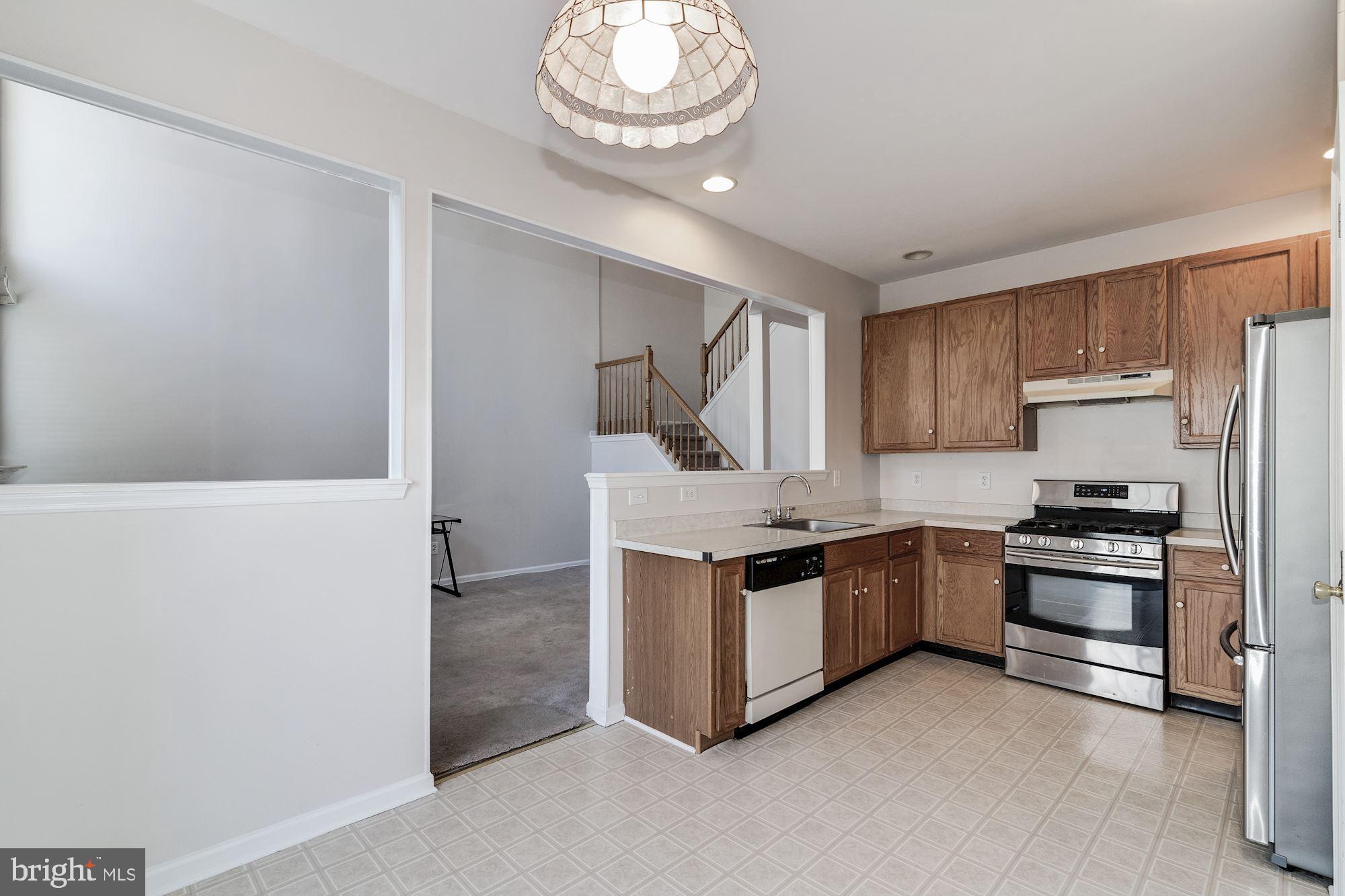 63 Threadleaf Terrace Burlington, NJ 08016 - Photo 12 of 34 a kitchen with stainless steel appliances a stove a sink and a refrigerator