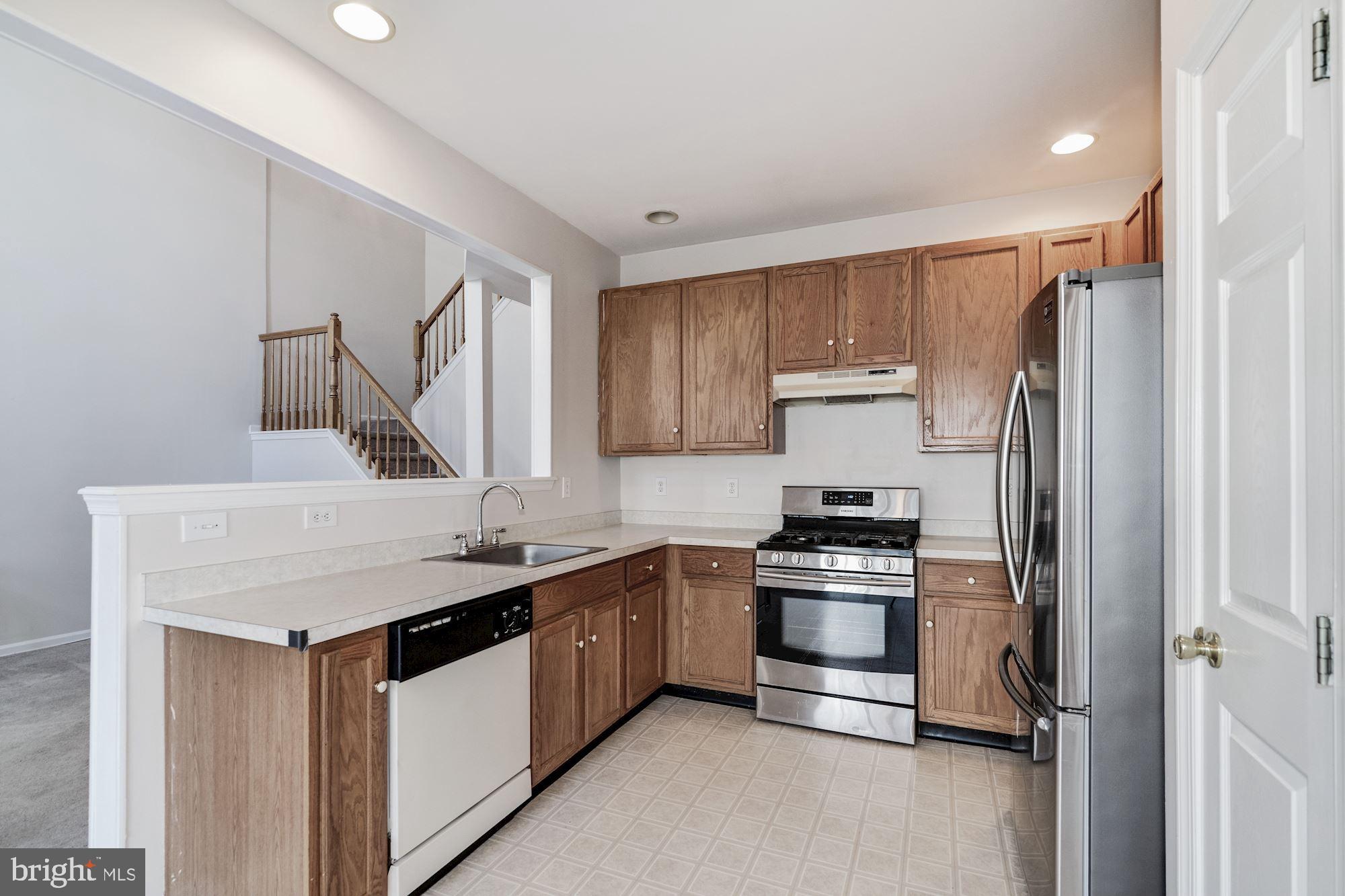 63 Threadleaf Terrace Burlington, NJ 08016 - Photo 13 of 34 a kitchen with stainless steel appliances granite countertop a sink stove and refrigerator