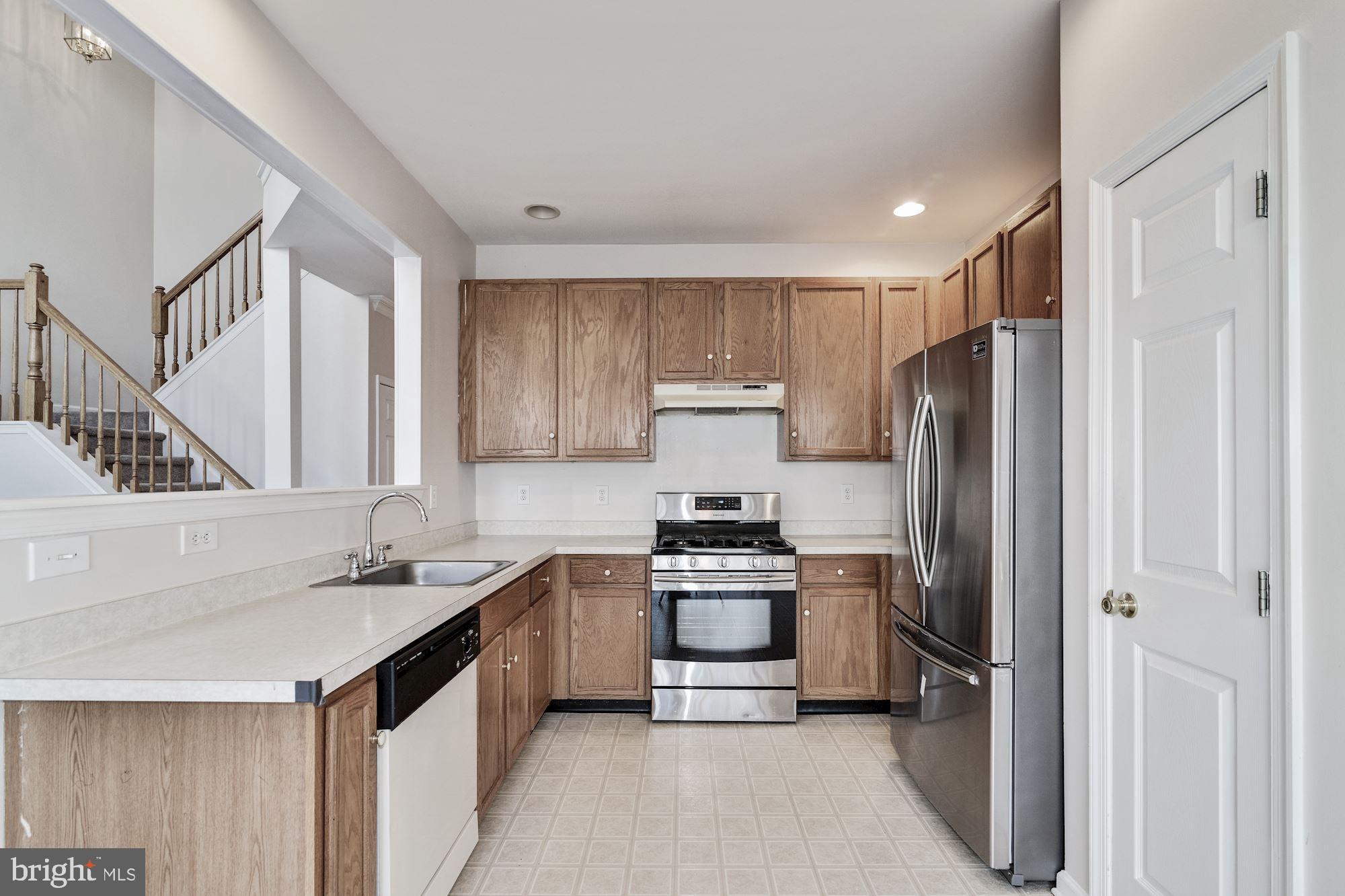 63 Threadleaf Terrace Burlington, NJ 08016 - Photo 14 of 34 a kitchen with a refrigerator a sink and cabinets