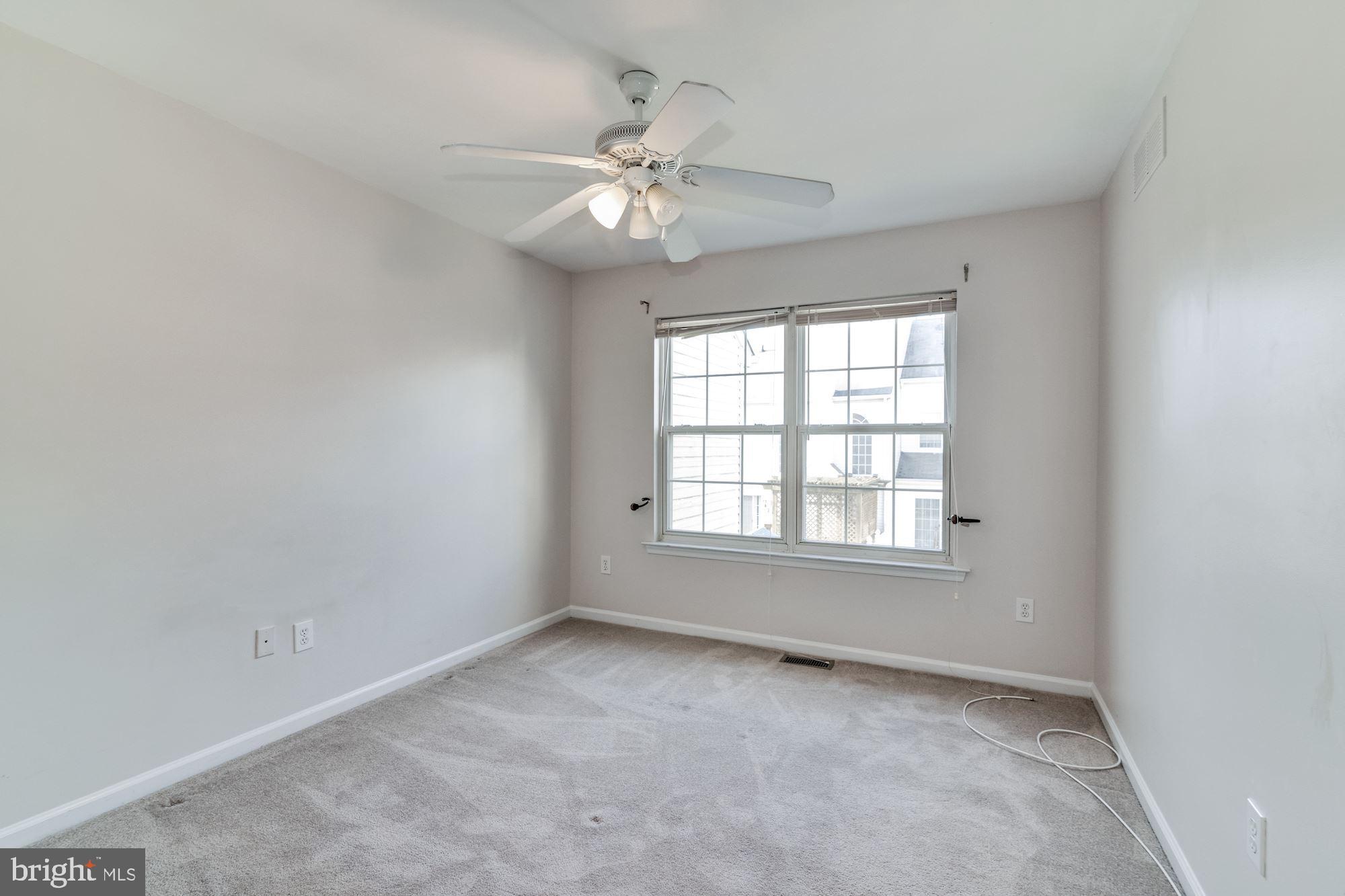 63 Threadleaf Terrace Burlington, NJ 08016 - Photo 27 of 34 an empty room with a chandelier fan and windows