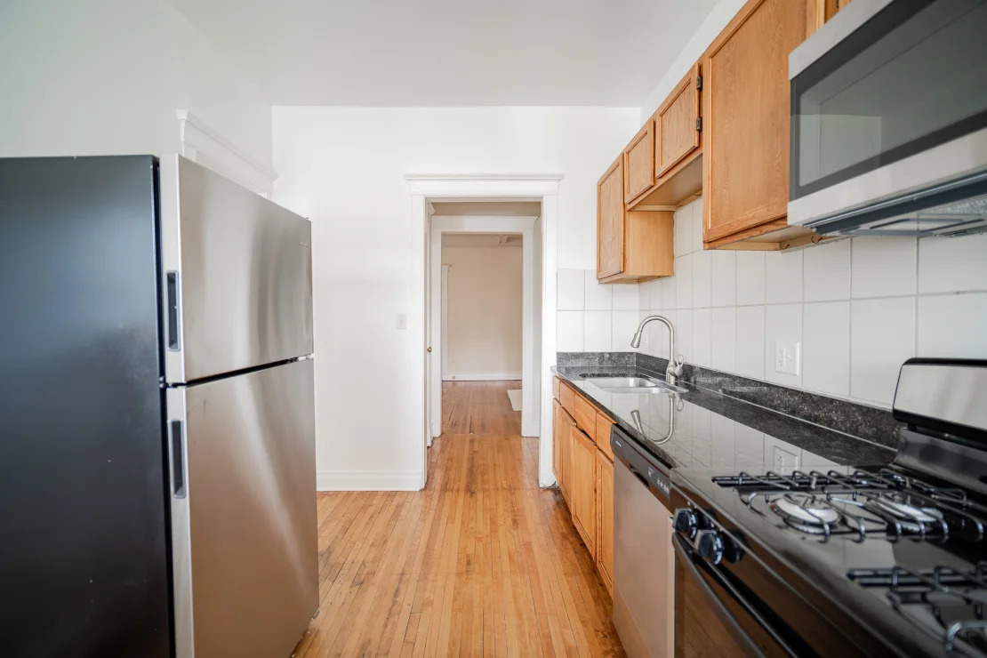 5124 South University Avenue Chicago, IL 60615 - Photo 3 of 8 a kitchen with a stove a refrigerator and a sink