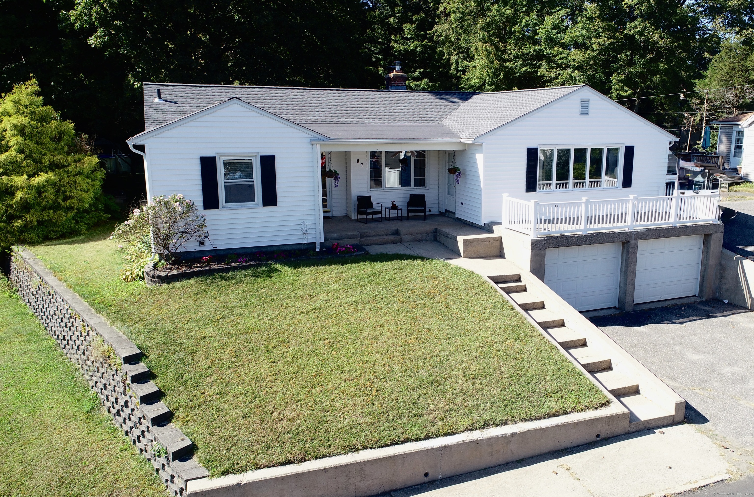 87 Lewis Street Naugatuck, CT 06770 - Photo 1 of 1 a front view of a house with a yard table and chairs