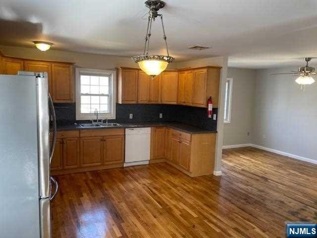 22 Broadway, Unit 2 Hackensack, NJ 07601 - Photo 4 of 8 a kitchen with a refrigerator and a stove top oven