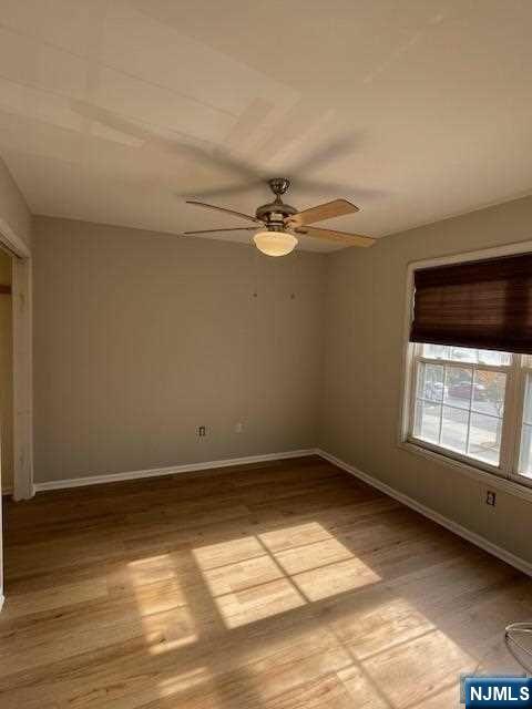 22 Broadway, Unit 2 Hackensack, NJ 07601 - Photo 5 of 8 wooden floor in an empty room with a window