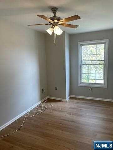 22 Broadway, Unit 2 Hackensack, NJ 07601 - Photo 7 of 8 a view of an empty room with wooden floor and a window