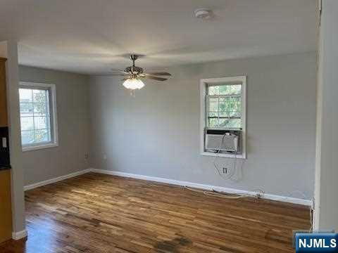 22 Broadway, Unit 2 Hackensack, NJ 07601 - Photo 8 of 8 a view of an empty room with wooden floor and a window
