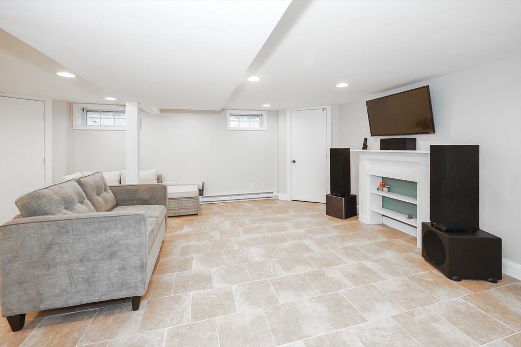 170 New Estate Road Littleton, MA 01460 - Photo 19 of 28 a living room with furniture and a flat screen tv