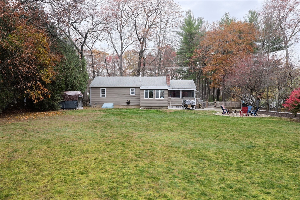 170 New Estate Road Littleton, MA 01460 - Photo 22 of 28 a view of a house with a big yard and large trees