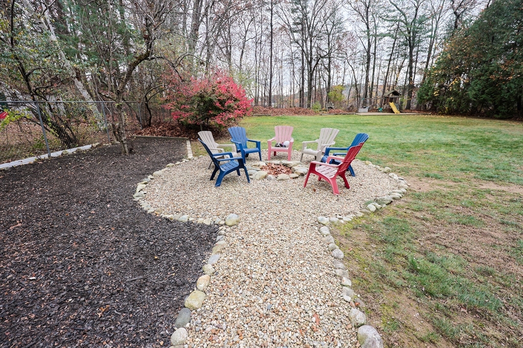 170 New Estate Road Littleton, MA 01460 - Photo 23 of 28 a view of a table and chairs in the garden