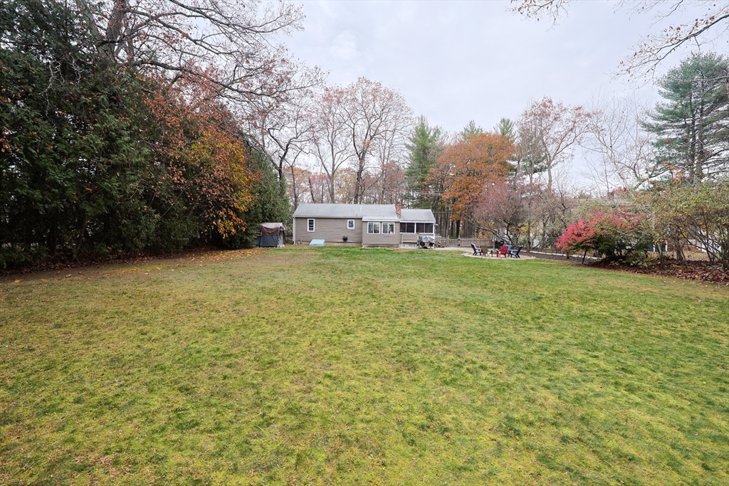 170 New Estate Road Littleton, MA 01460 - Photo 25 of 28 a view of a house with a big yard and large trees
