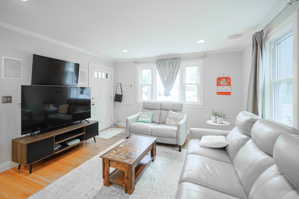 170 New Estate Road Littleton, MA 01460 - Photo 3 of 28 a living room with furniture and a flat screen tv