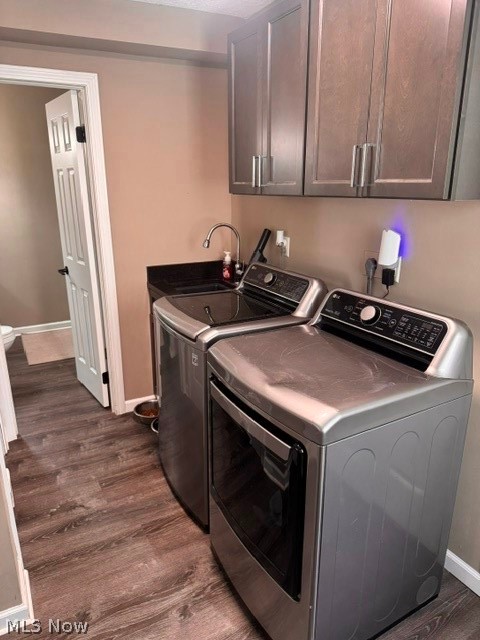2760 Haines Road Madison, OH 44057 - Photo 33 of 33 Dedicated laundry area featuring wood-finish flooring, neutral wall tones, and gray cabinetry with brushed nickel hardware