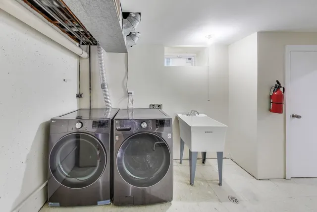 a utility room with sink dryer and washer