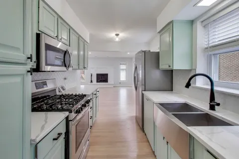 a kitchen with stainless steel appliances a sink stove and refrigerator