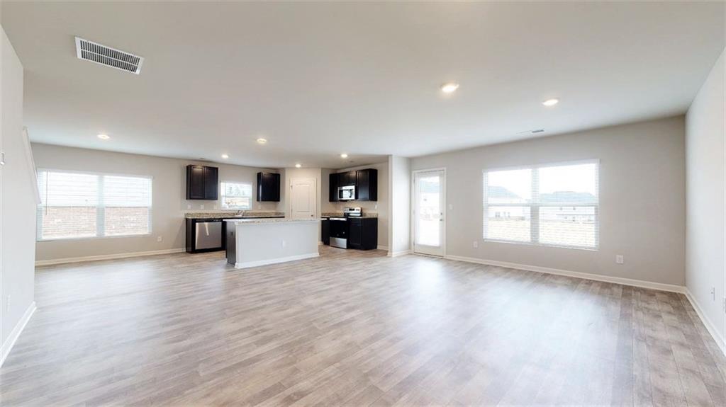 121 Weldon Road McDonough, GA 30253 - Photo 17 of 32 a big room with wooden floor and windows
