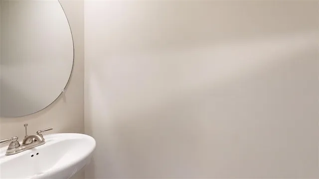 a bathroom with a sink and mirror