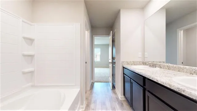 a bathroom with a granite countertop sink a toilet and shower