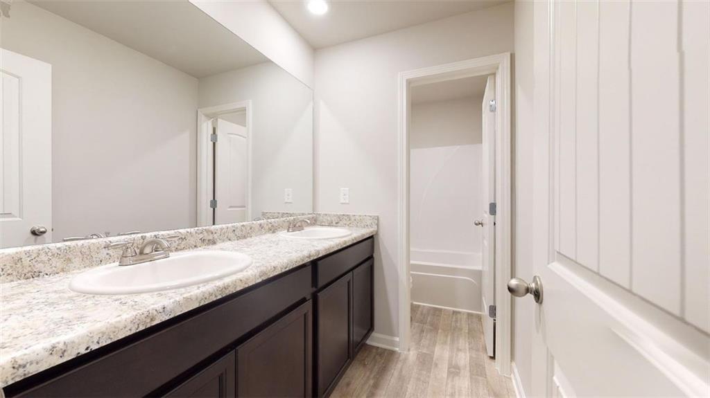 121 Weldon Road McDonough, GA 30253 - Photo 30 of 32 a bathroom with a granite countertop sink and a mirror