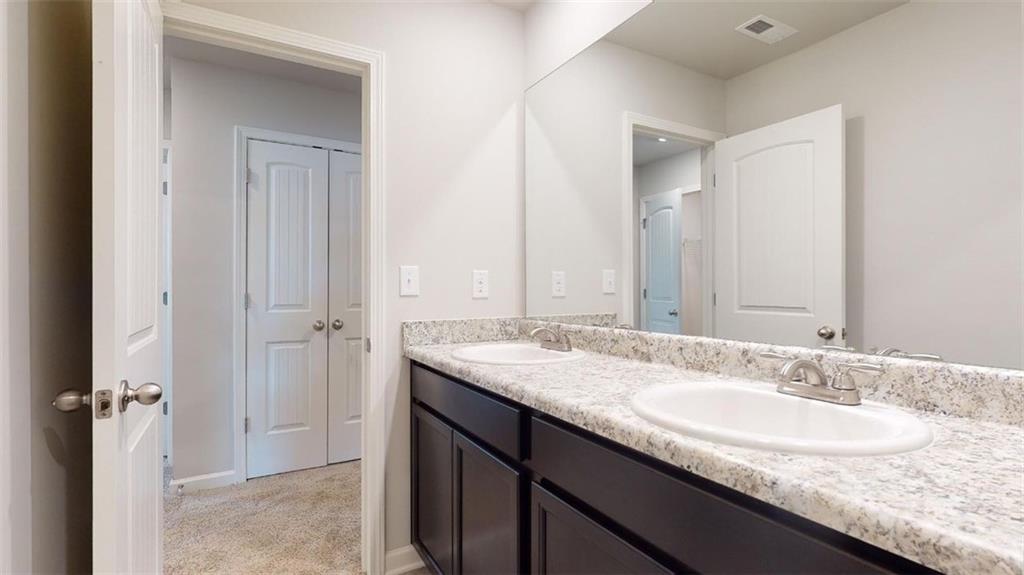 121 Weldon Road McDonough, GA 30253 - Photo 31 of 32 a bathroom with a granite countertop sink and a mirror