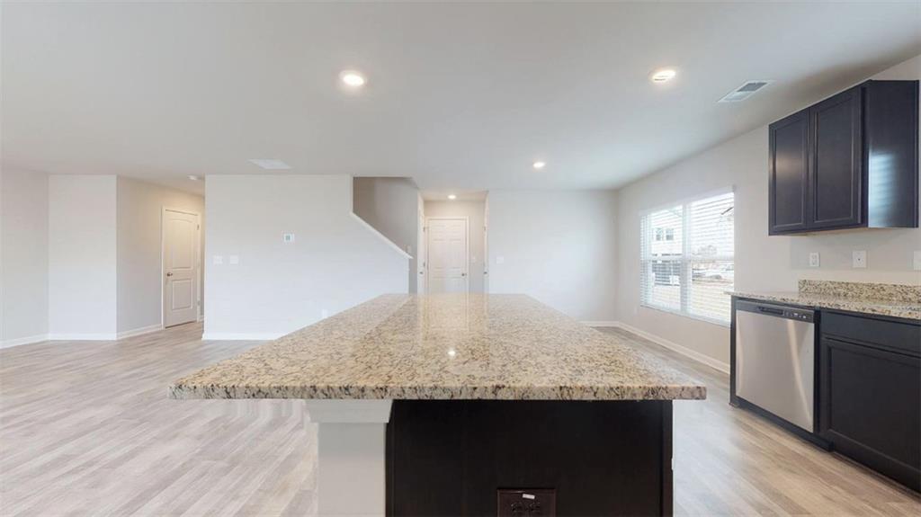 121 Weldon Road McDonough, GA 30253 - Photo 6 of 32 a kitchen with granite countertop kitchen island a sink appliances and a counter space
