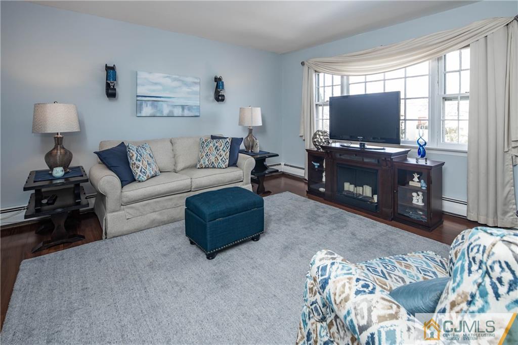 207 South Hill Road Colonia, NJ 07067 - Photo 11 of 47 a living room with furniture and a flat screen tv