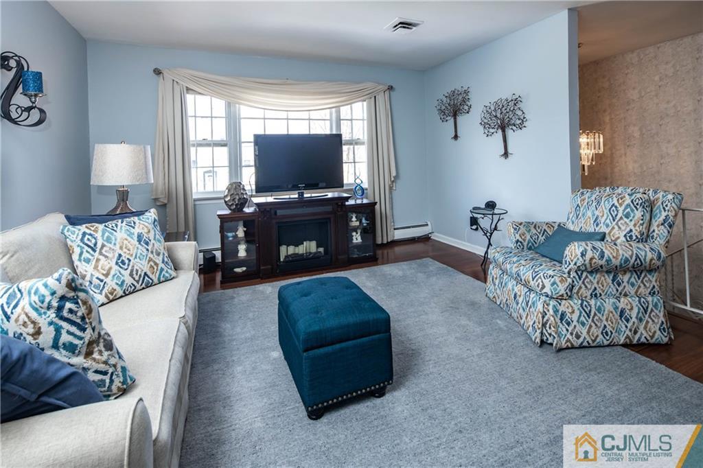 207 South Hill Road Colonia, NJ 07067 - Photo 12 of 47 a living room with furniture and a flat screen tv