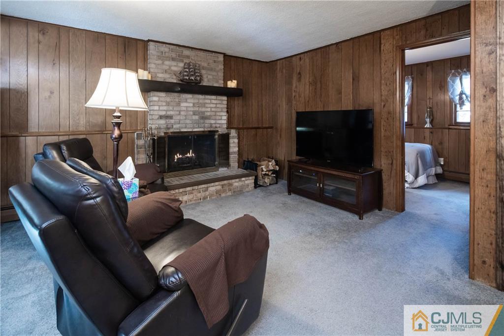 207 South Hill Road Colonia, NJ 07067 - Photo 23 of 47 a living room with furniture and a flat screen tv