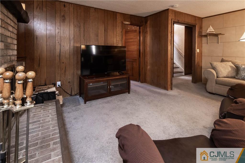 207 South Hill Road Colonia, NJ 07067 - Photo 24 of 47 a living room with furniture and a flat screen tv