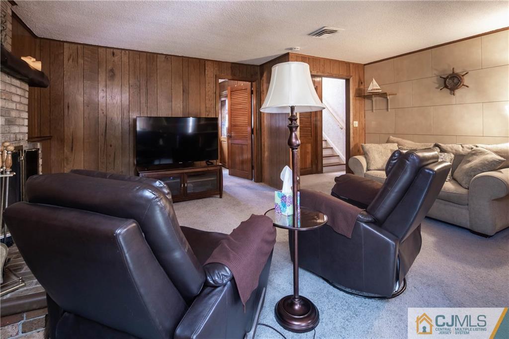 207 South Hill Road Colonia, NJ 07067 - Photo 25 of 47 a living room with furniture and a flat screen tv