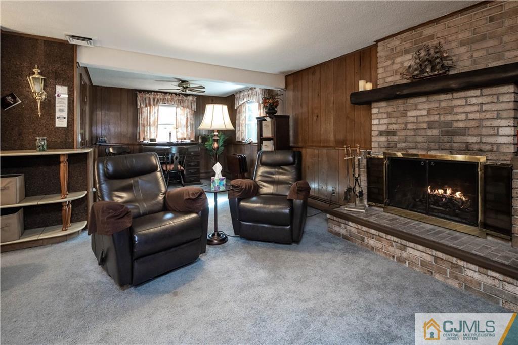 207 South Hill Road Colonia, NJ 07067 - Photo 27 of 47 a living room with furniture and a fireplace