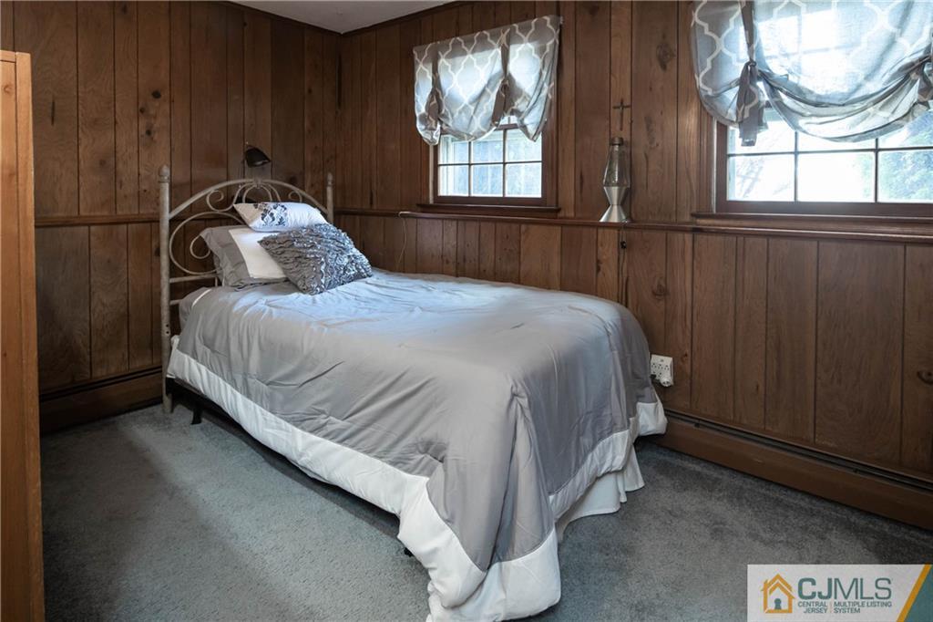 207 South Hill Road Colonia, NJ 07067 - Photo 29 of 47 a bed sitting in a bedroom next to a window