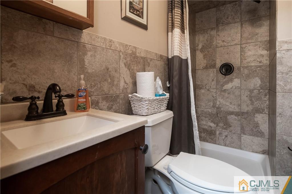 207 South Hill Road Colonia, NJ 07067 - Photo 30 of 47 a bathroom with a sink a toilet and shower
