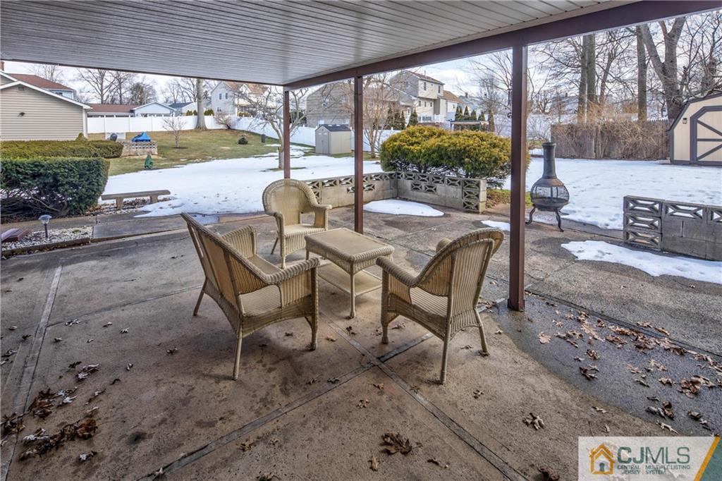 207 South Hill Road Colonia, NJ 07067 - Photo 34 of 47 a view of a patio with a table chairs and a backyard