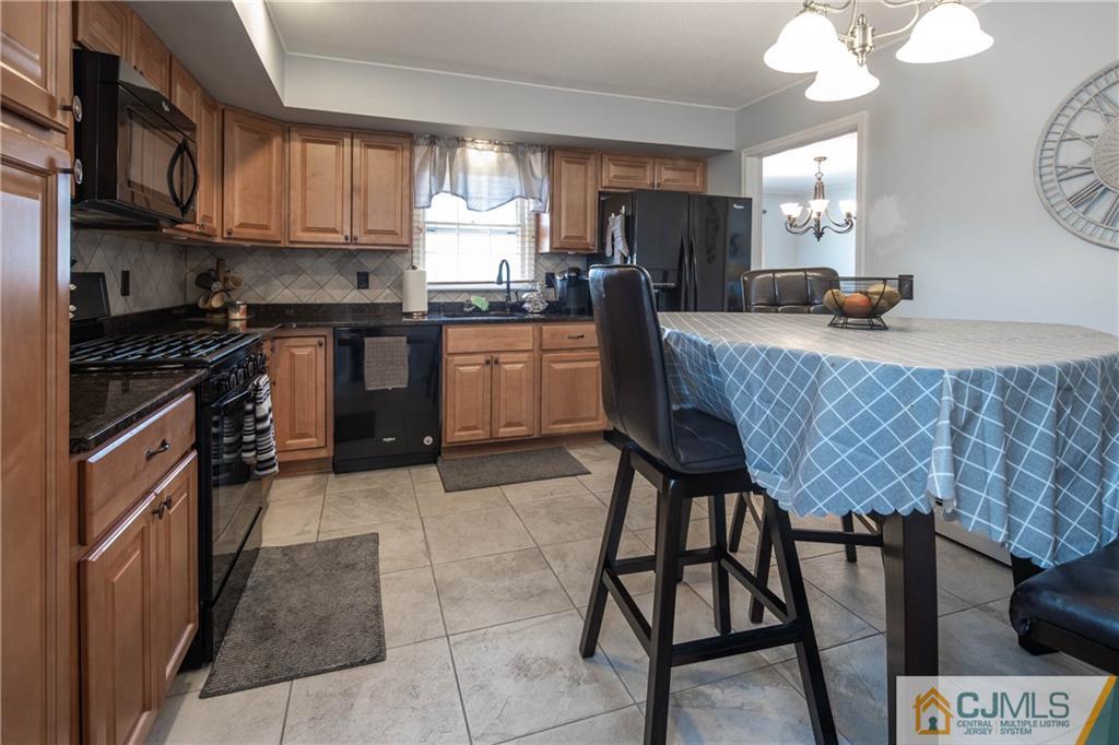 207 South Hill Road Colonia, NJ 07067 - Photo 6 of 47 a kitchen with stainless steel appliances granite countertop a stove top oven a sink dishwasher and cabinets