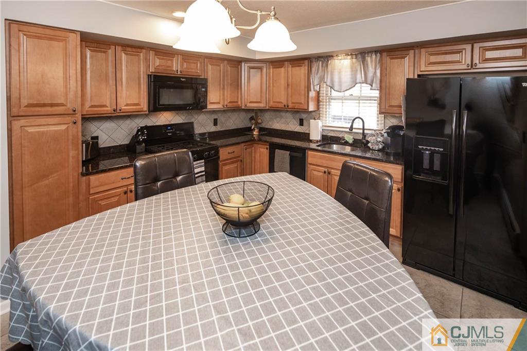 207 South Hill Road Colonia, NJ 07067 - Photo 7 of 47 a kitchen with stainless steel appliances a sink a stove a microwave a refrigerator a sink and cabinets