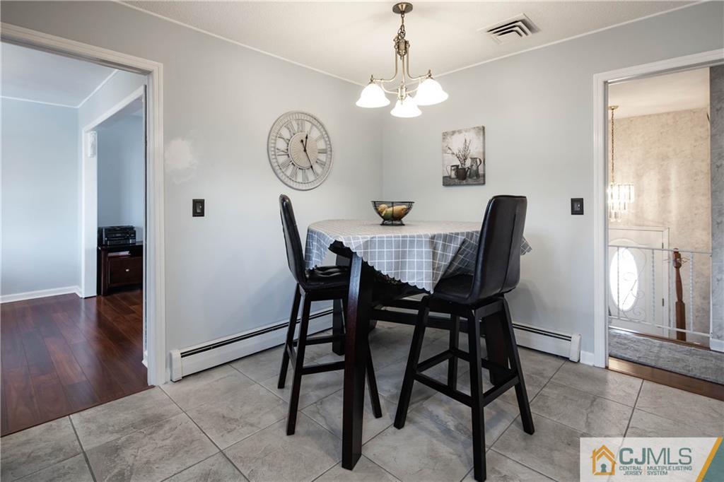 207 South Hill Road Colonia, NJ 07067 - Photo 10 of 47 a view of a dining room with furniture and wooden floor